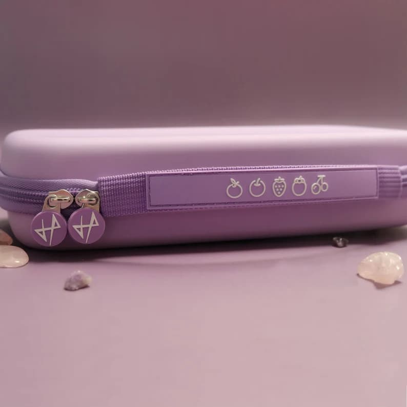 Side view of lavender Nintendo Switch Cosmic Moon carrying case showing zipper and star charm pulls