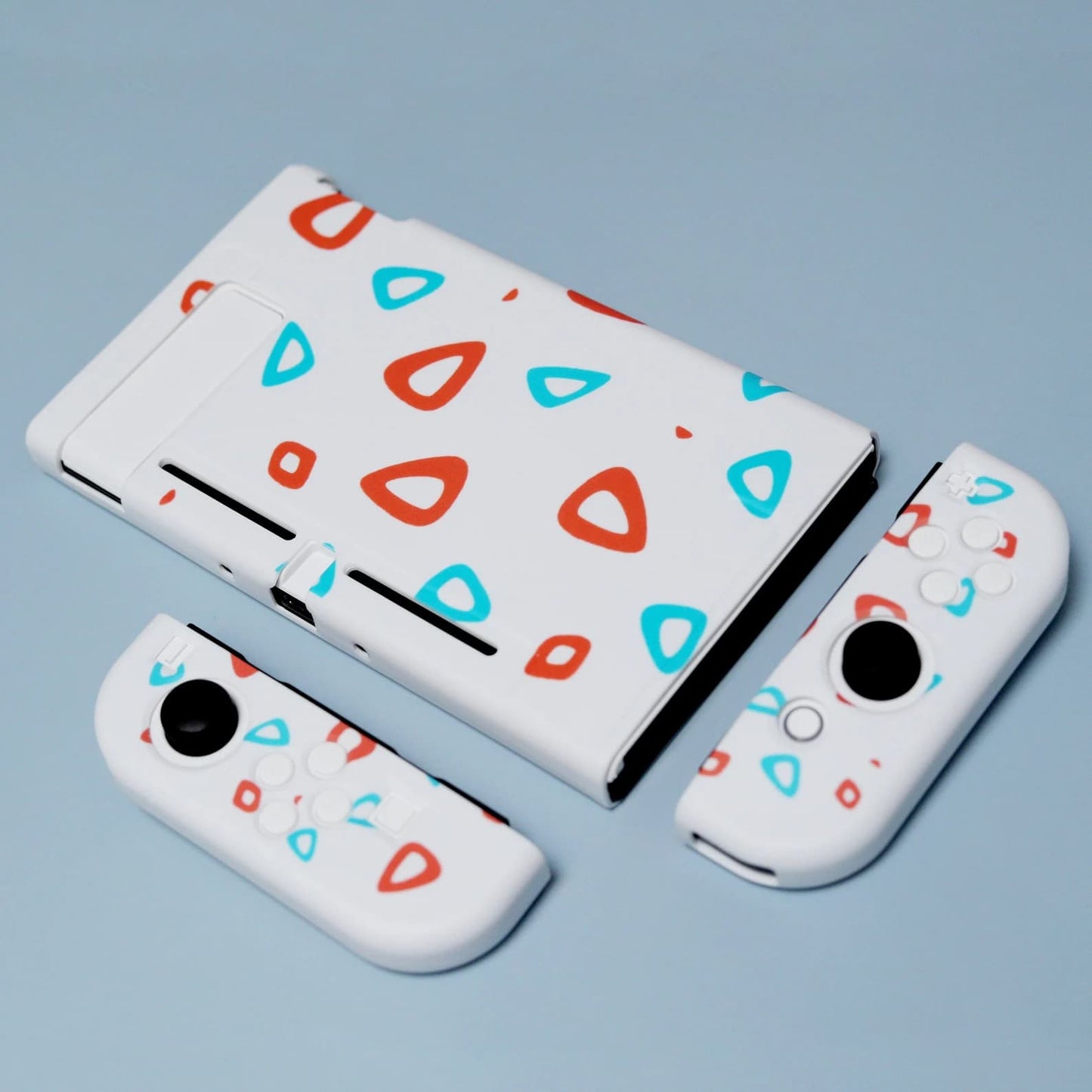 Full Nintendo Switch Egg case set in white TPU with red and teal eggshell pattern including console shell and detached Joy-Con covers