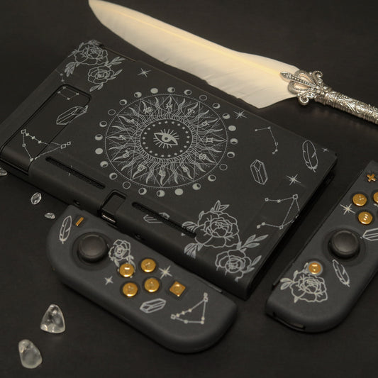 Black Nintendo Switch Solaris Noire soft-shell case and Joy-Con covers with white celestial sun eye design, roses and constellations, styled with crystals