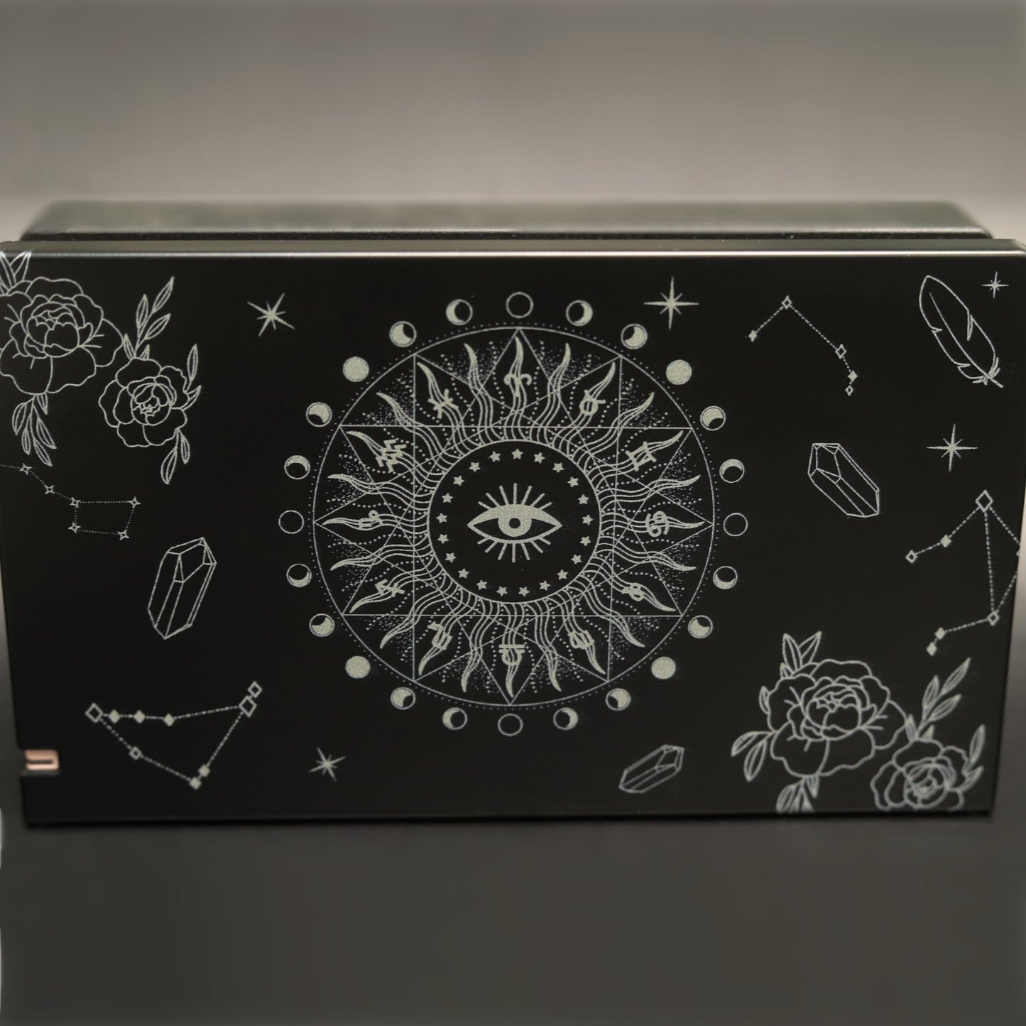 Black Nintendo Switch dock cover with white Solaris Noire celestial sun eye, moon phases, roses and crystal pattern