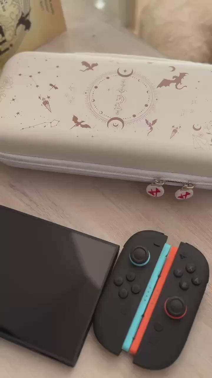 Short video showing the Emberwing carry case with dragon and moon print, plus matching Joy-Cons on a wooden surface.